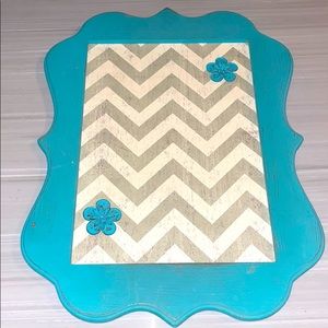 Chevron magnetic board with two flower magnets.